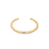 A sleek gold-plated brass cuff bracelet rests on a clean white background.