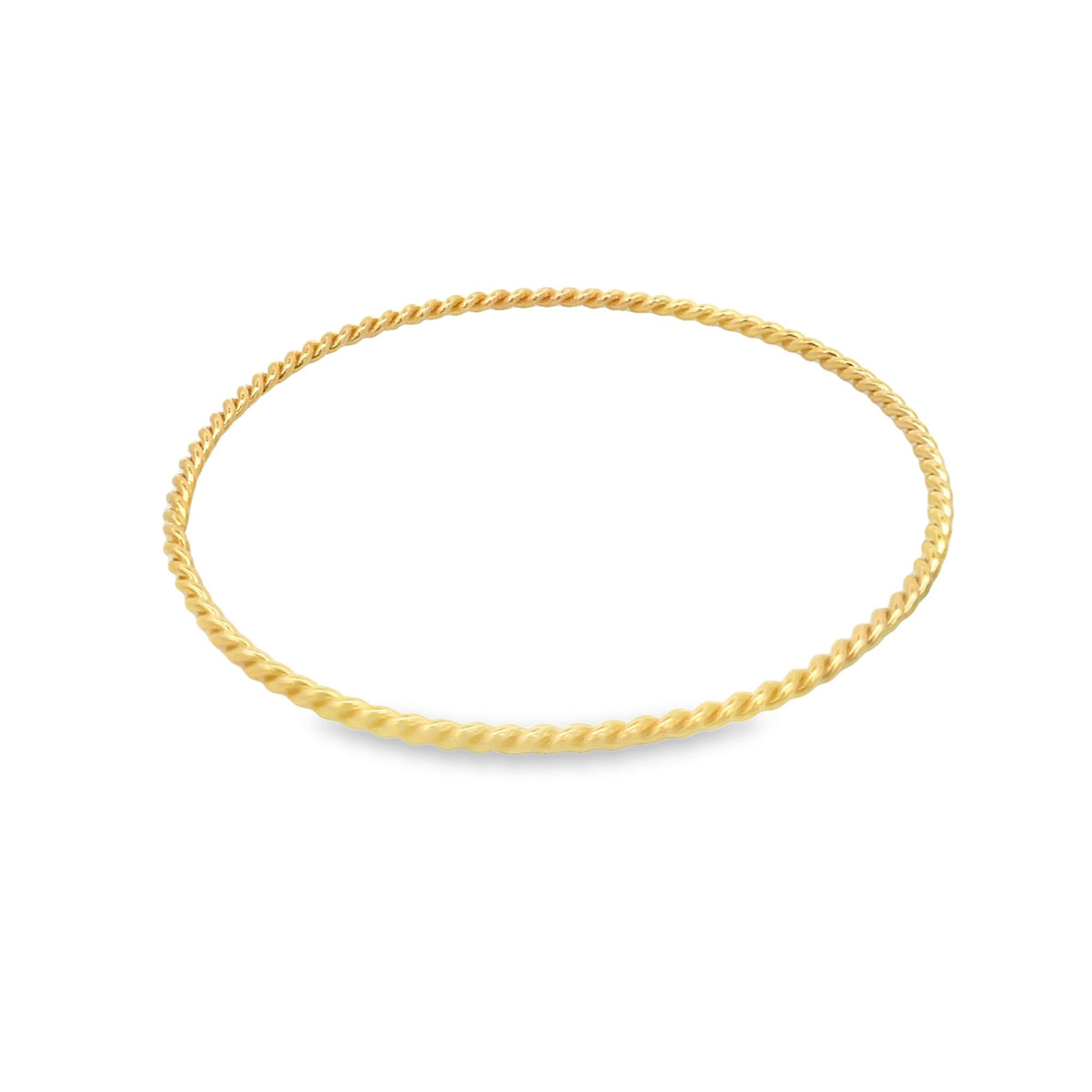 A sleek gold twisted wire bangle bracelet rests on a clean white background.