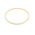 A simple thin gold bangle bracelet rests against a clean white background.