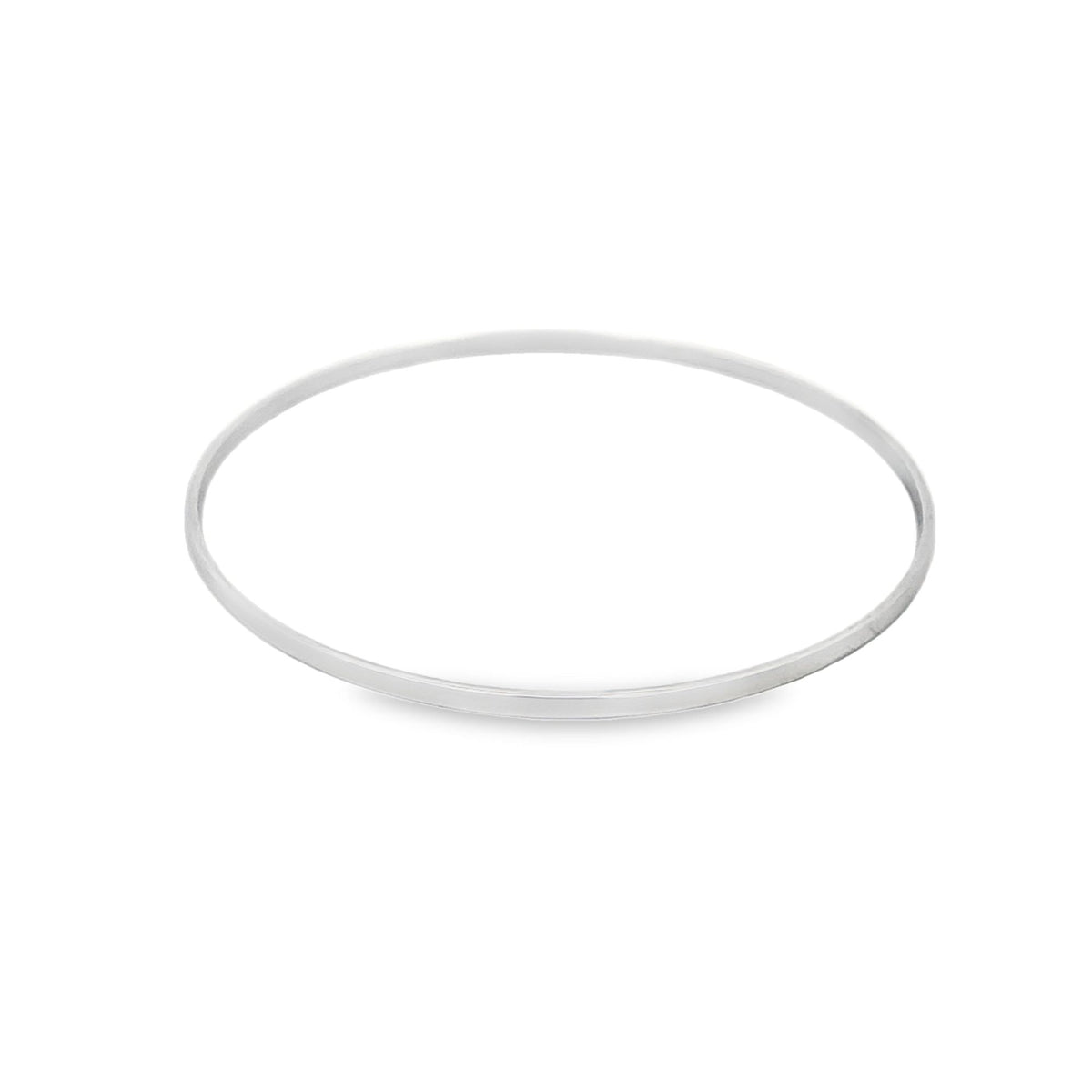 A sleek silver bangle rests on a clean white surface.