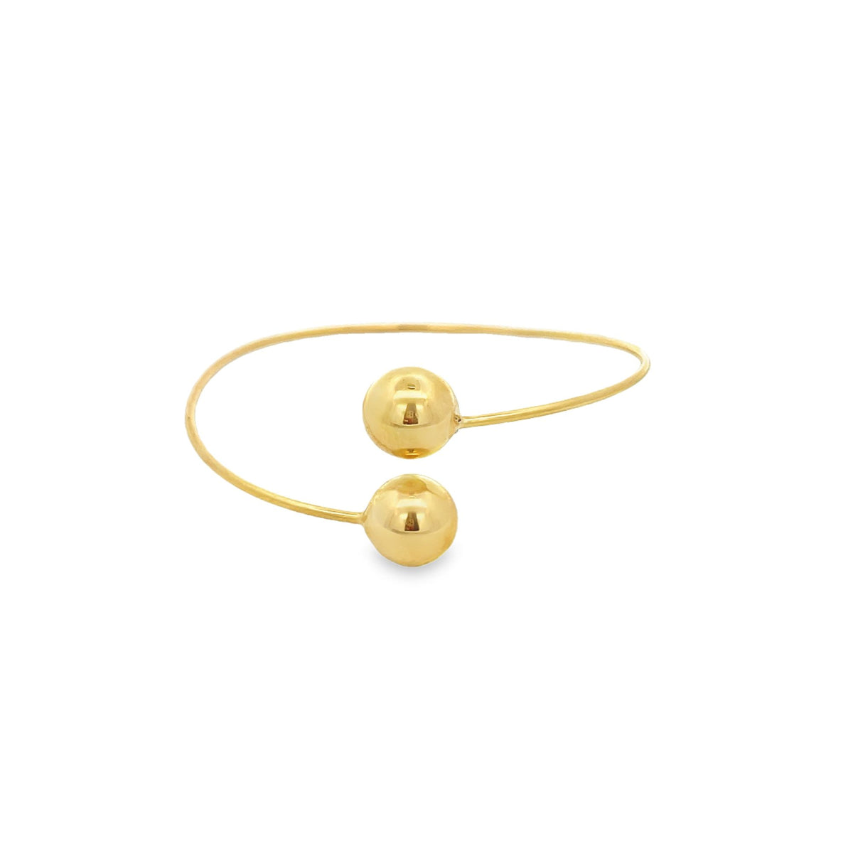 A sleek gold cuff bracelet features polished spherical ends against a clean white background.