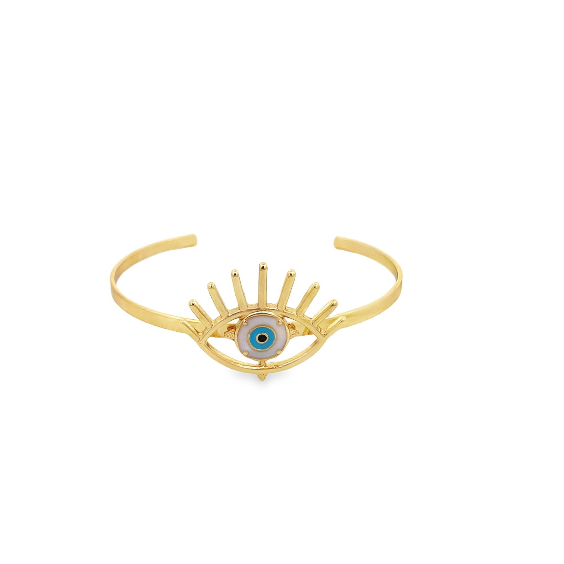 A gold cuff bracelet features an evil eye charm with blue, white, and black enamel.