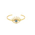 A gold cuff bracelet features an evil eye charm with blue, white, and black enamel.
