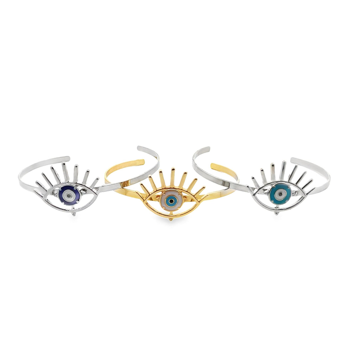 Three stylish evil eye cuff bracelets in gold and silver display intricate eyelash details and colorful enamel centers against a clean white background.