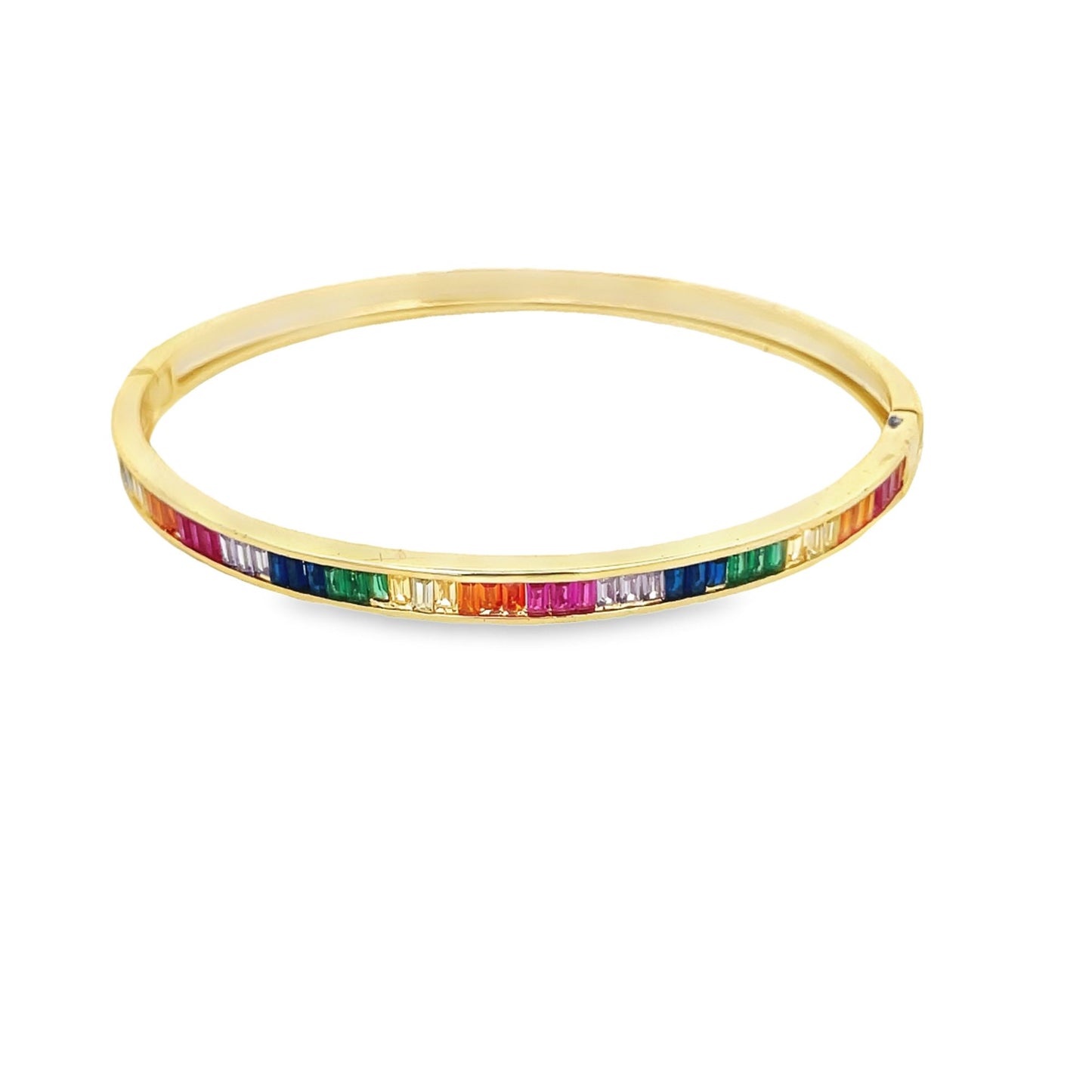 A gold bangle bracelet sparkles with a continuous channel of vibrant, multi-colored baguette-cut gemstones against a clean white background.