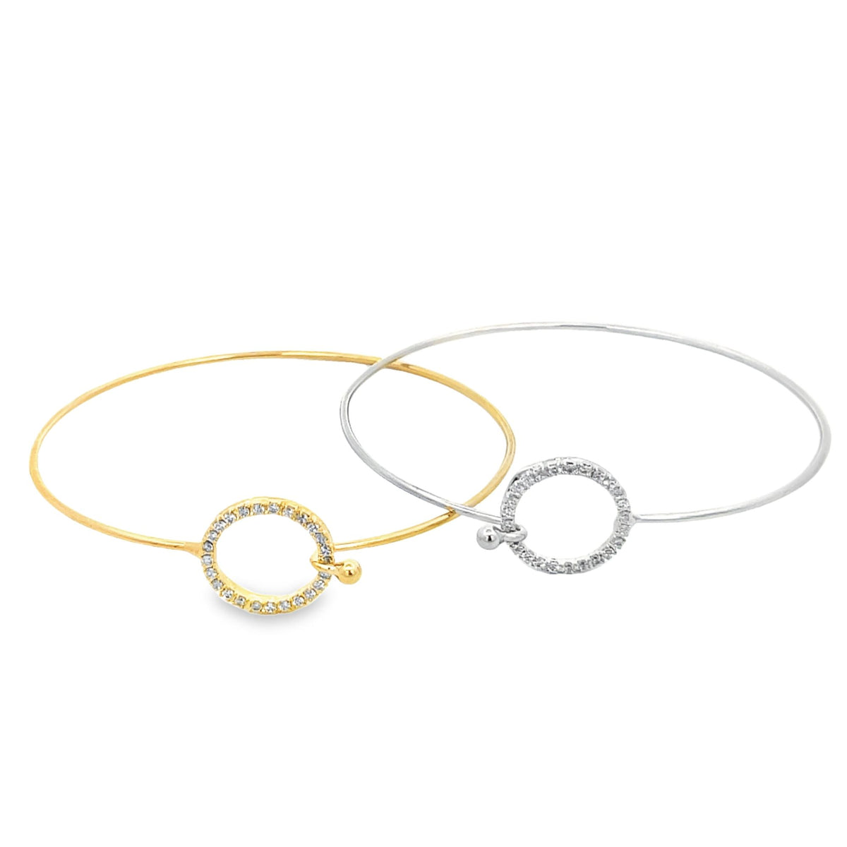 Two elegant gold and silver bangle bracelets feature pavé-set diamond circle clasps resting against a clean white background.