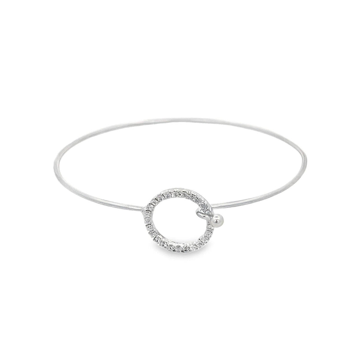 A delicate silver bangle bracelet features a sparkling pavé-set diamond circle charm as its centerpiece against a clean white background.