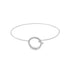 A delicate silver bangle bracelet features a sparkling pavé-set diamond circle charm as its centerpiece against a clean white background.