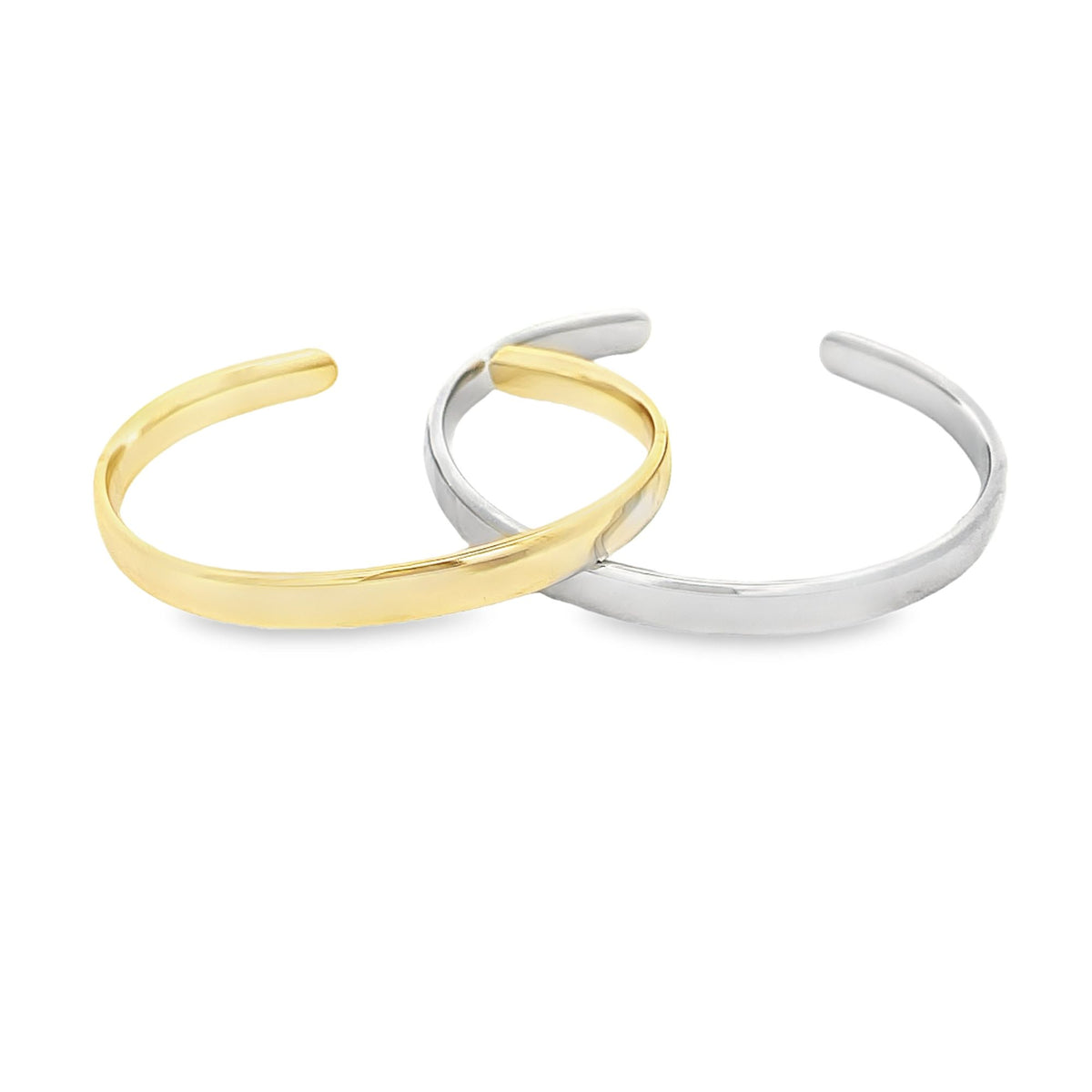 Two interlocking minimalist gold and silver cuff bracelets rest on a clean white background.