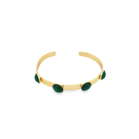 A sleek gold cuff bracelet features four polished green cabochon stones evenly spaced along the band.