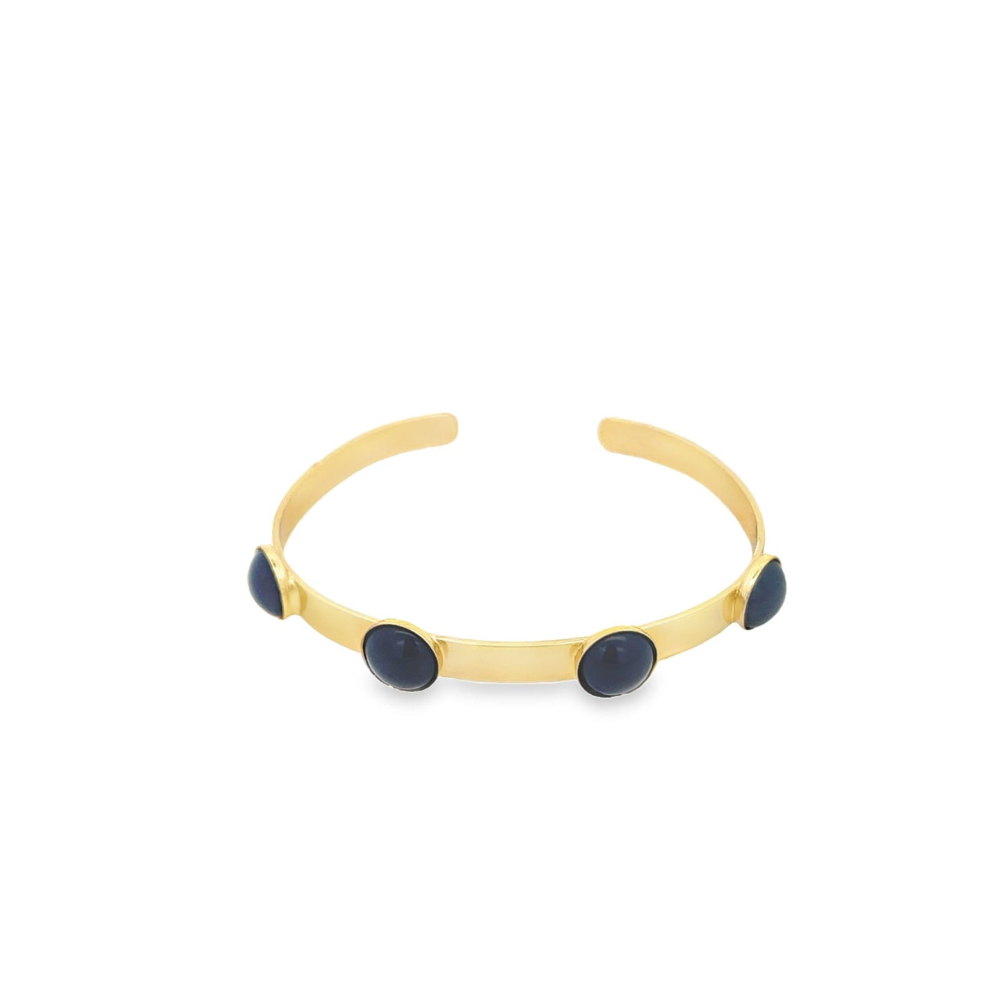 A sleek gold cuff bracelet features four round, dark blue stones spaced evenly along the band against a clean white background.