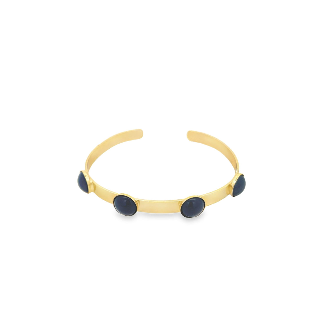 A sleek gold cuff bracelet features four round, dark blue stones spaced evenly along the band against a clean white background.