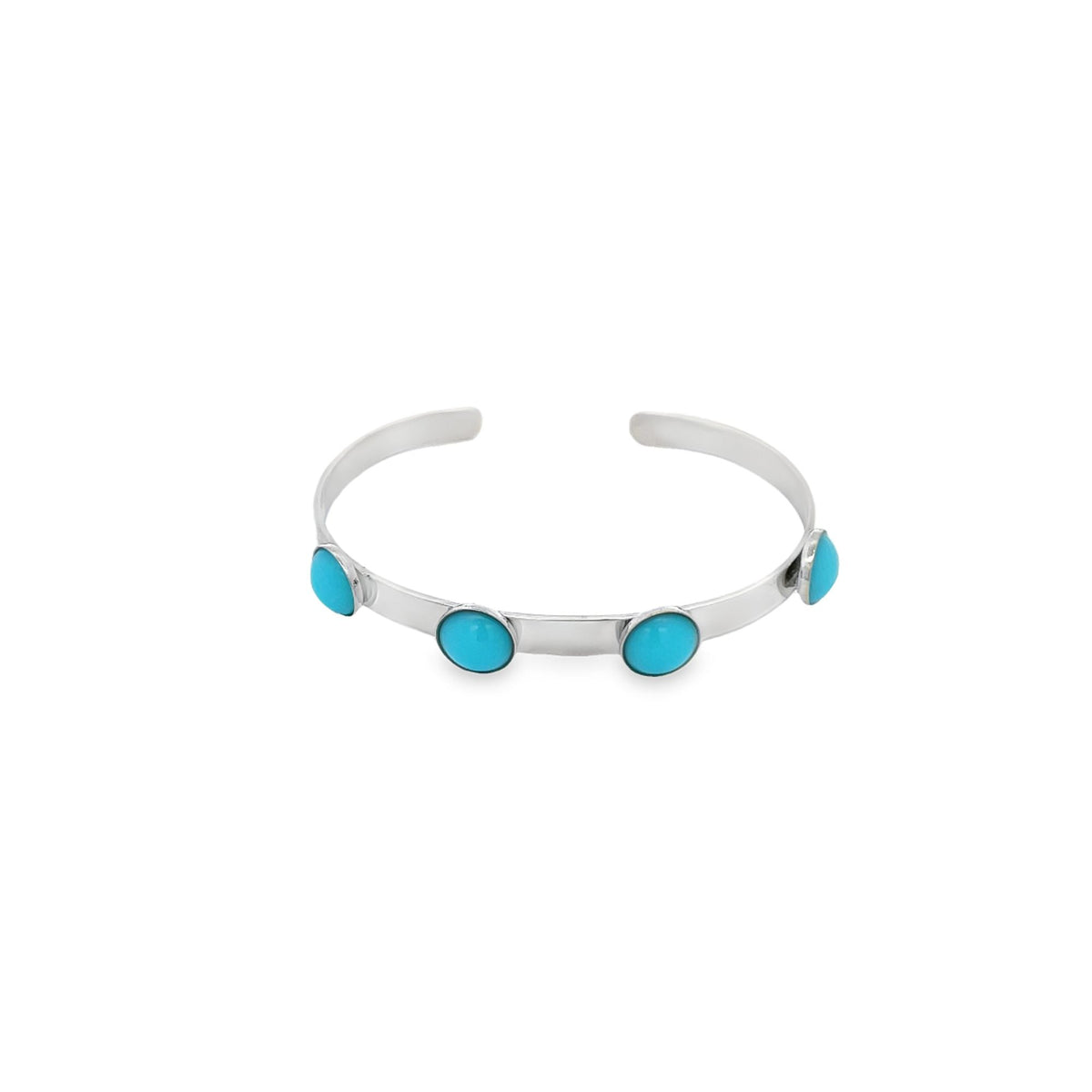 A silver cuff bracelet features four inlaid round turquoise stones against a clean white background.