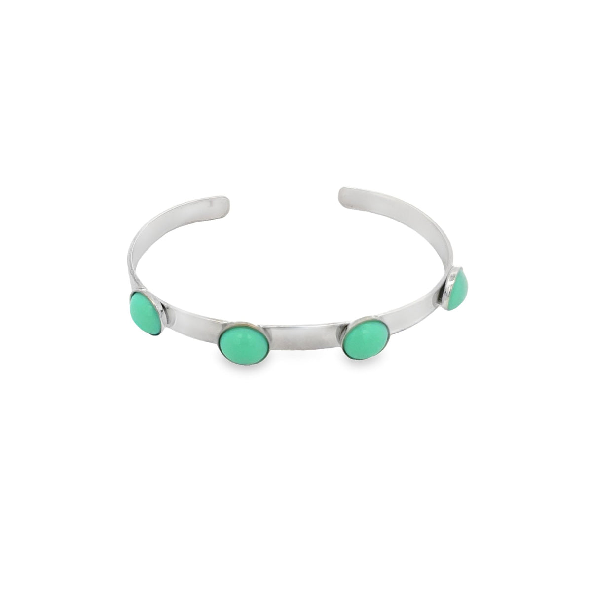 A sleek silver cuff bracelet features four vibrant turquoise stones evenly spaced along its polished band.