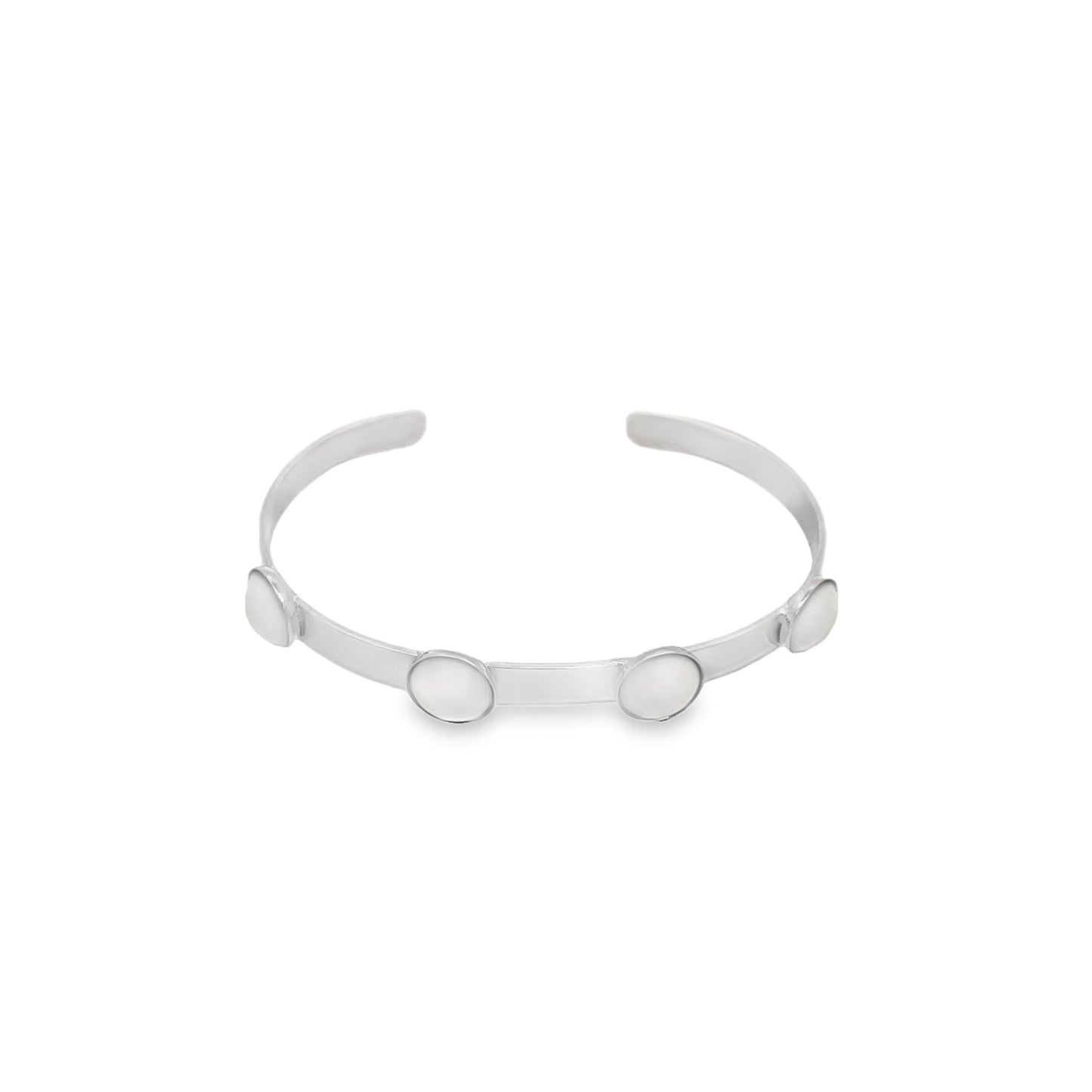 A sleek silver cuff bracelet features four round, mother-of-pearl cabochons spaced evenly along its polished band against a clean white background.