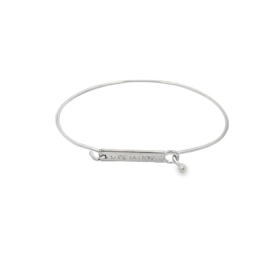 A sleek silver expandable bangle bracelet rests against a clean white background, highlighting its engraved inspirational bar.