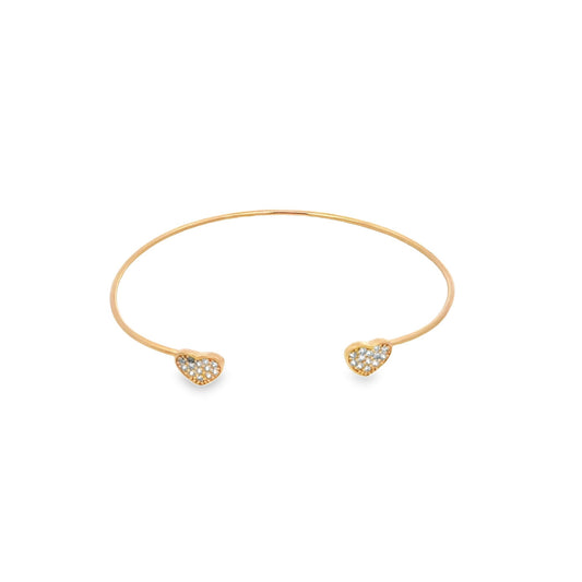 A delicate gold cuff bracelet features pavé-set diamond hearts at each open end.