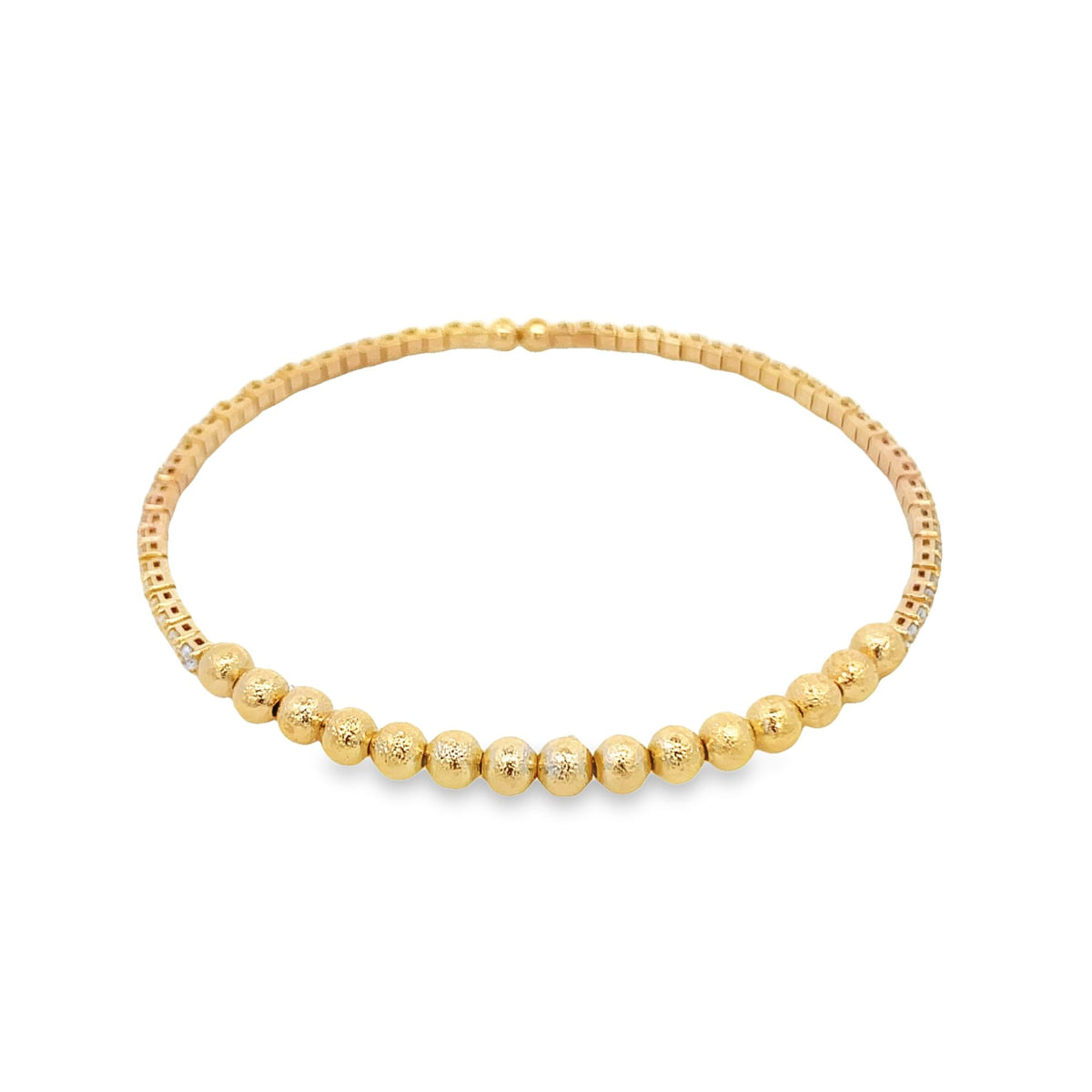 A delicate gold beaded bracelet displays a line of textured spheres curving gently against a plain white background.