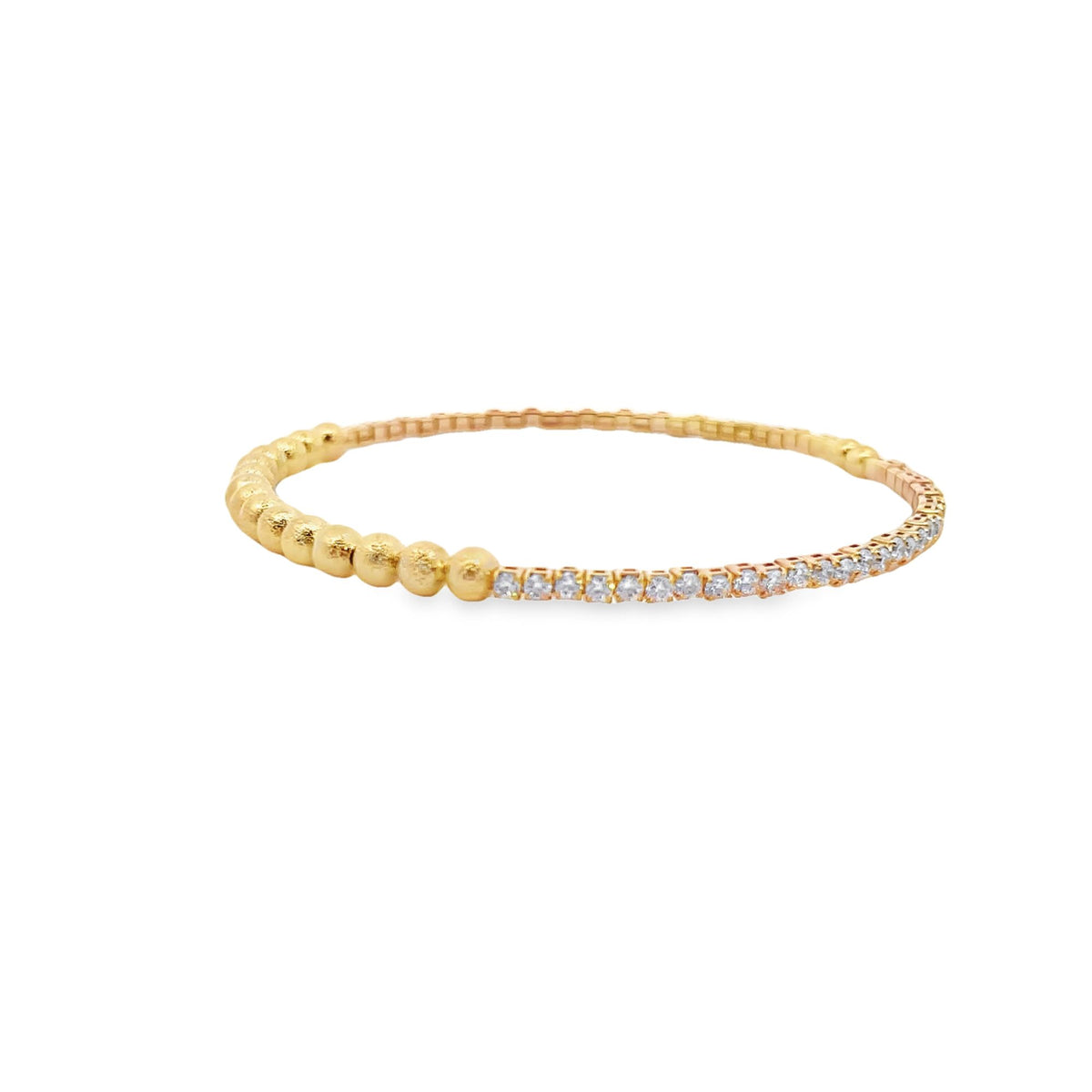 A delicate gold stretch bracelet features a row of sparkling diamonds on one half and textured gold beads on the other against a white background.