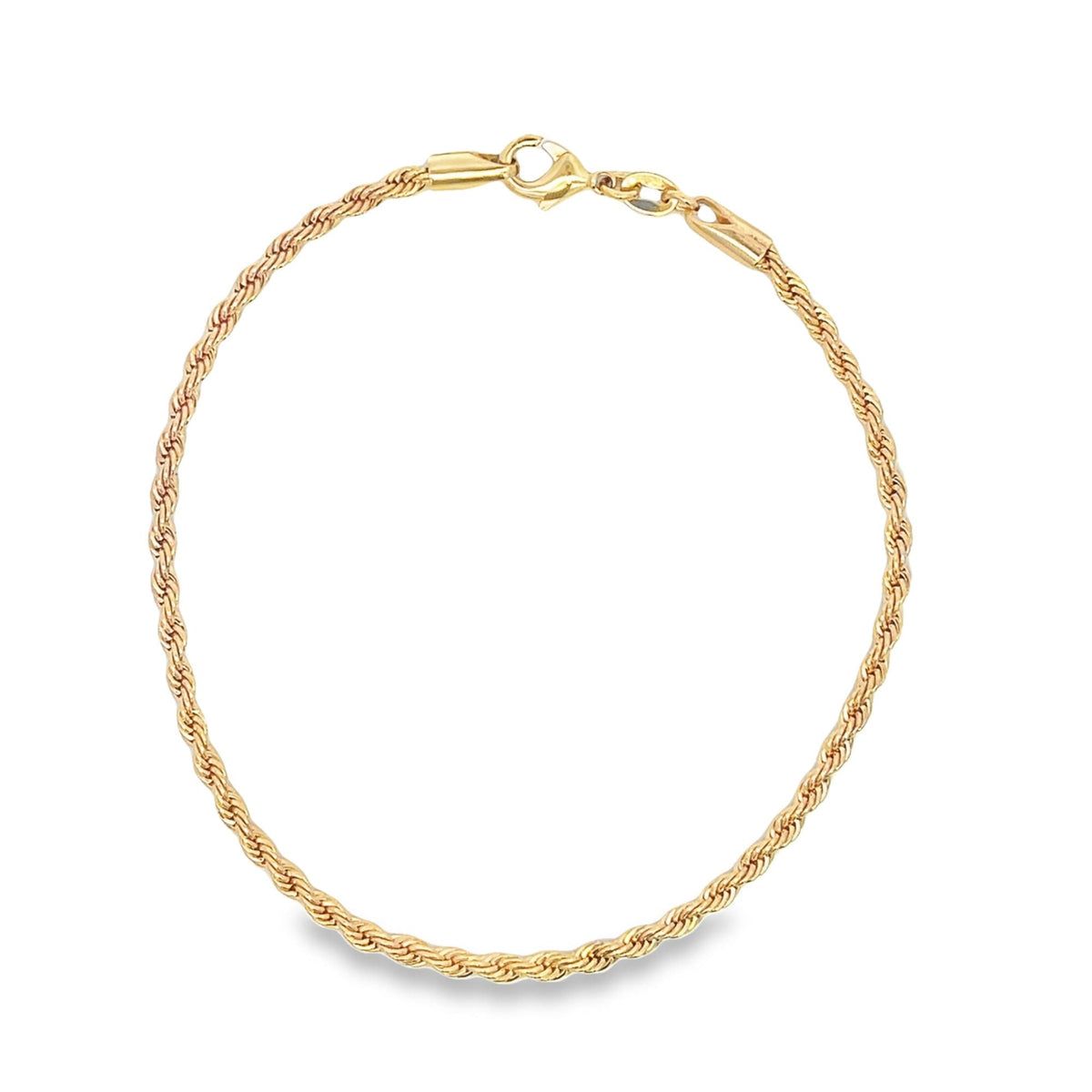 A delicate gold rope chain bracelet lies in a circle against a white background.