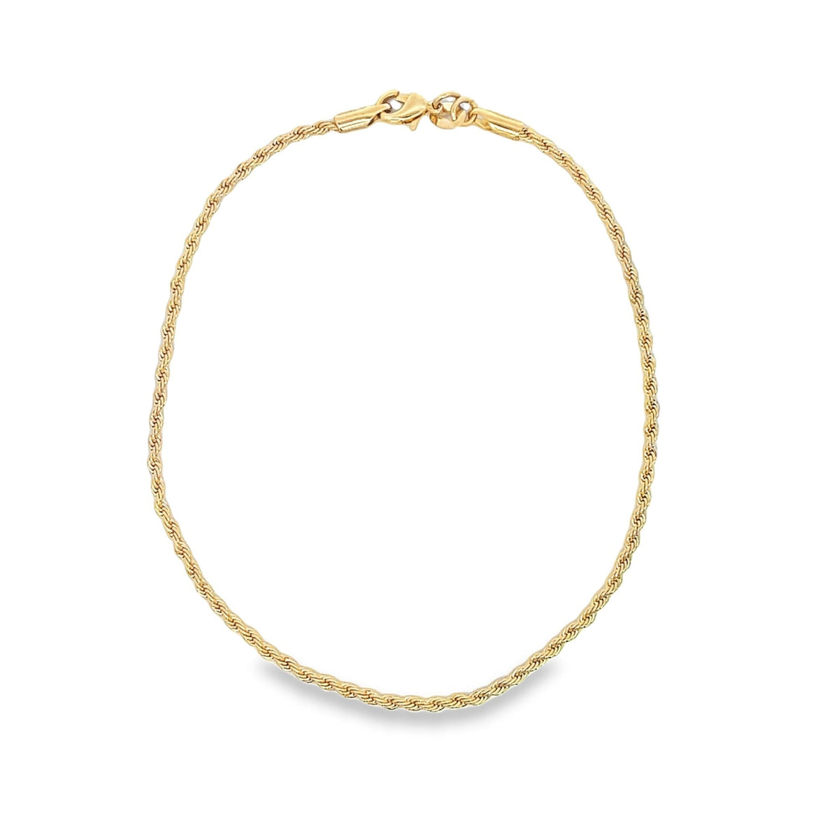 A delicate gold rope chain necklace curves gracefully against a plain white background, displaying its textured links and secure clasp.