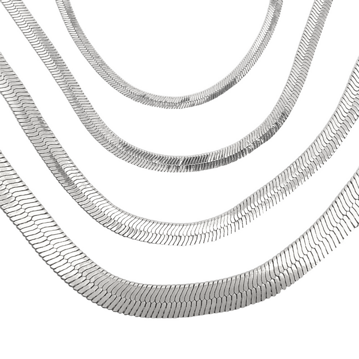 Four layered silver herringbone chains display their sleek, flat-link design against a plain white background.