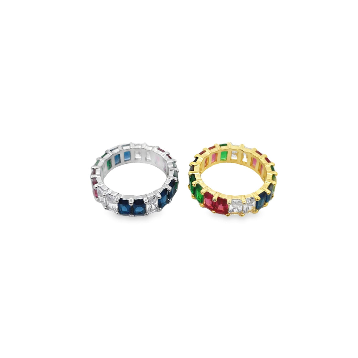 Two eternity bands sparkle with baguette-cut multi-color gemstone crystals, featuring one in silver and the other in gold.