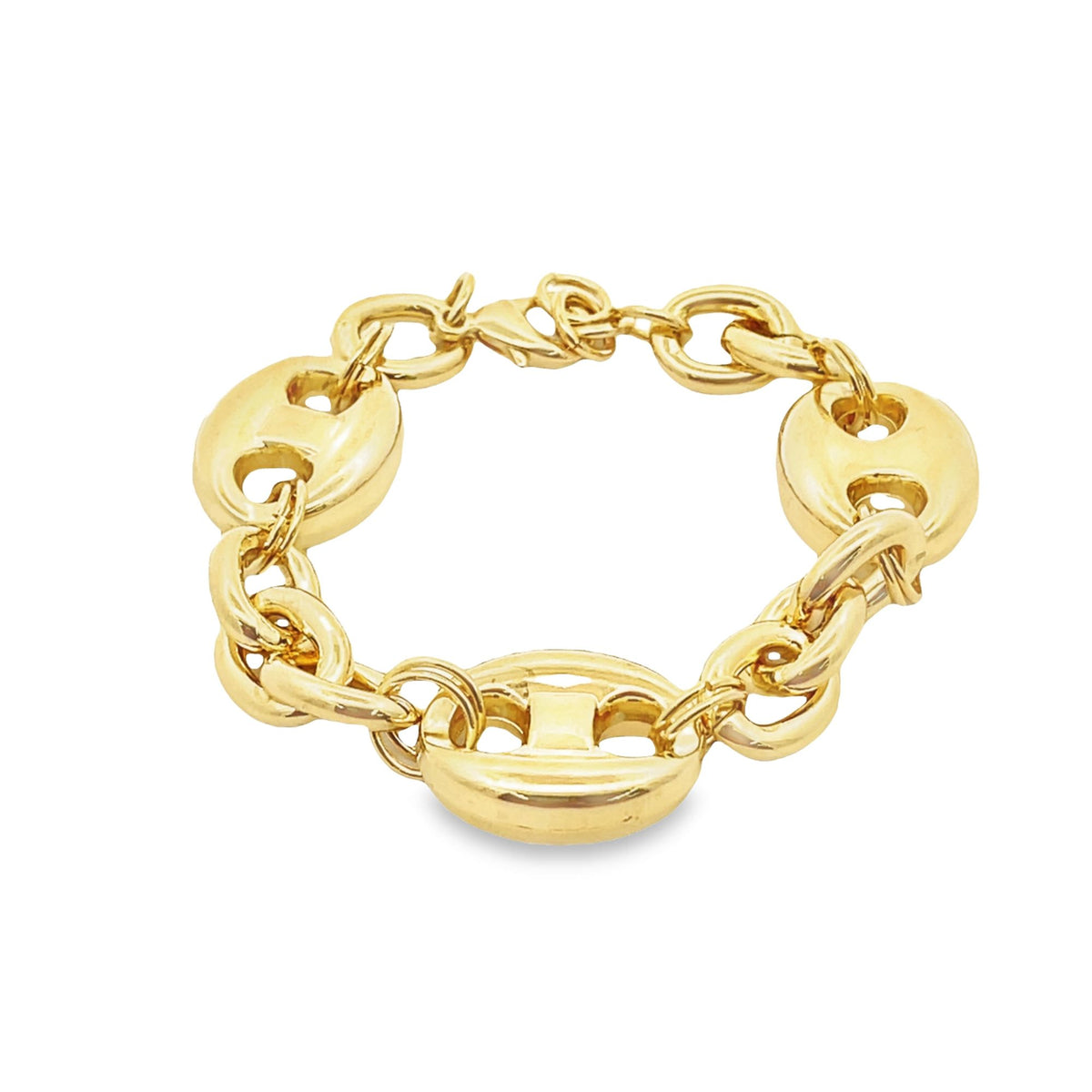 A chunky gold link bracelet lies in a gentle curve on a clean white background, showcasing its polished nautical-inspired design.