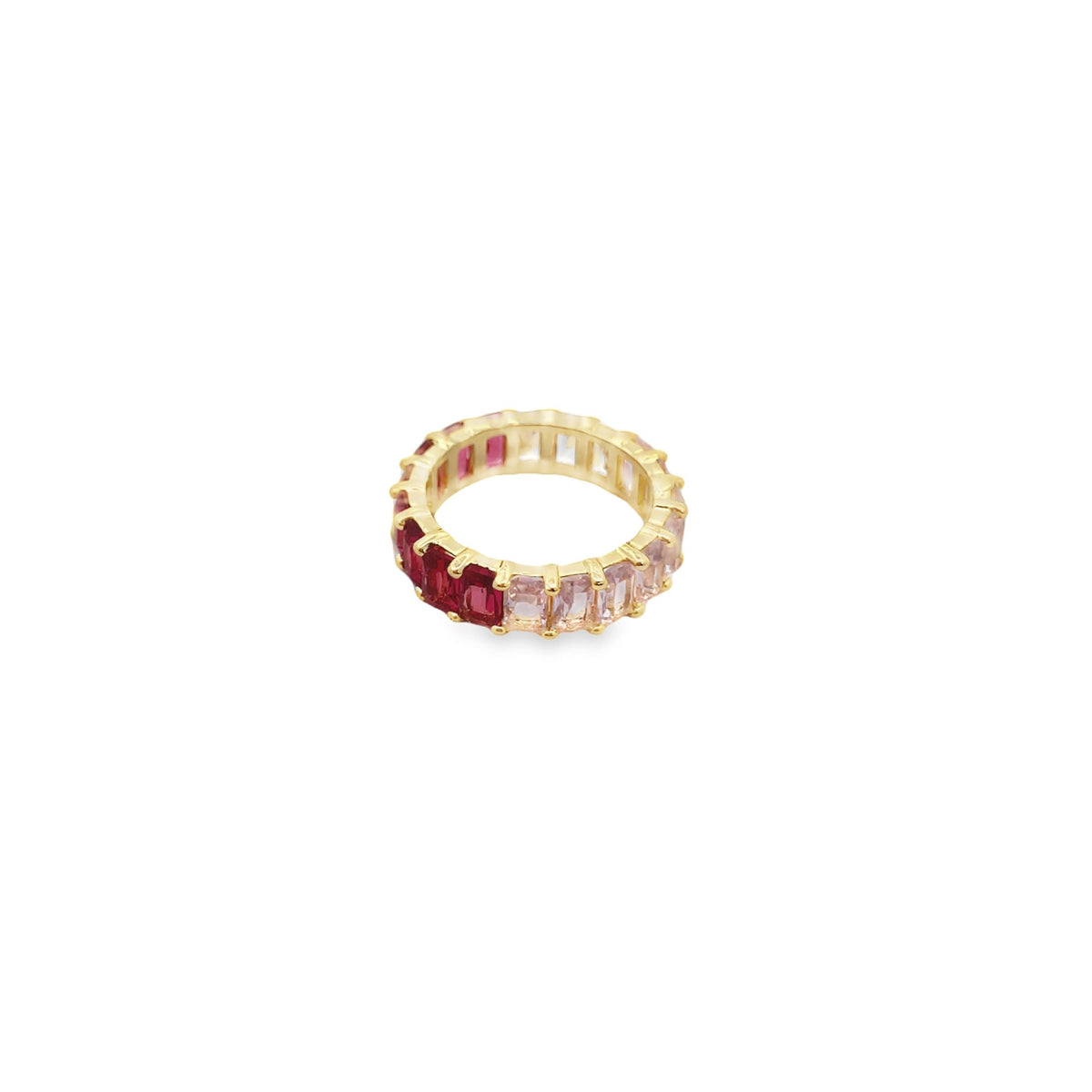 A gold eternity ring features a gradient of baguette-cut gemstones transitioning from deep red to pale pink.