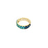 A gold eternity ring features an ombre of baguette-cut blue and teal gemstones against a plain white background.