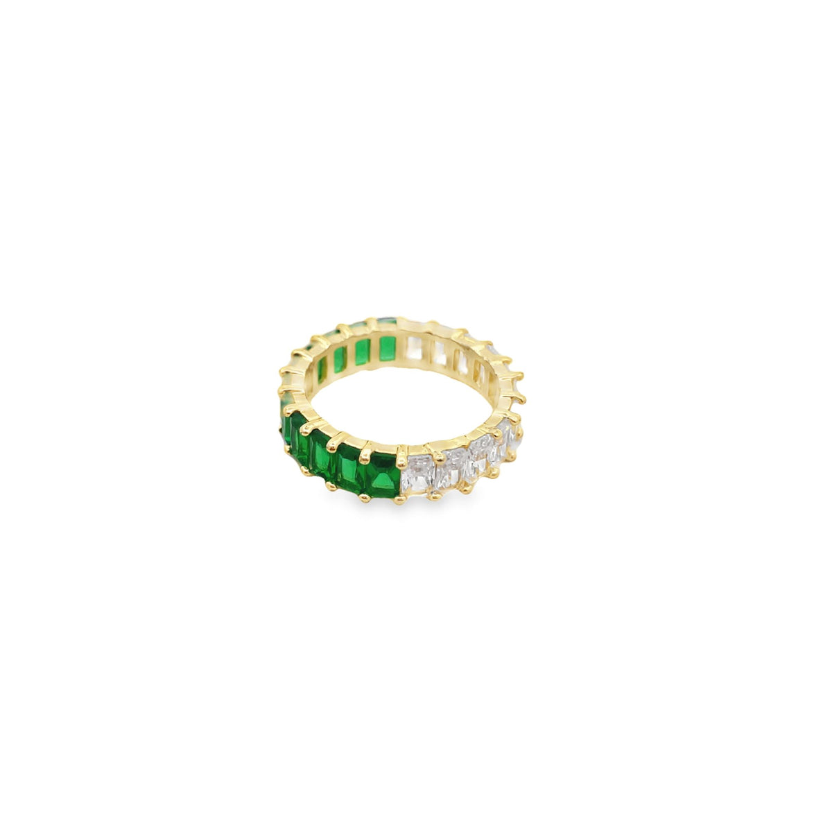 A gold eternity ring features an alternating half-and-half design of vibrant green emerald-cut stones and sparkling white cubic zirconia crystals.