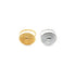 Two statement rings featuring ornate, round medallions lie side by side on a white background, with one crafted in polished gold and the other in gleaming silver.