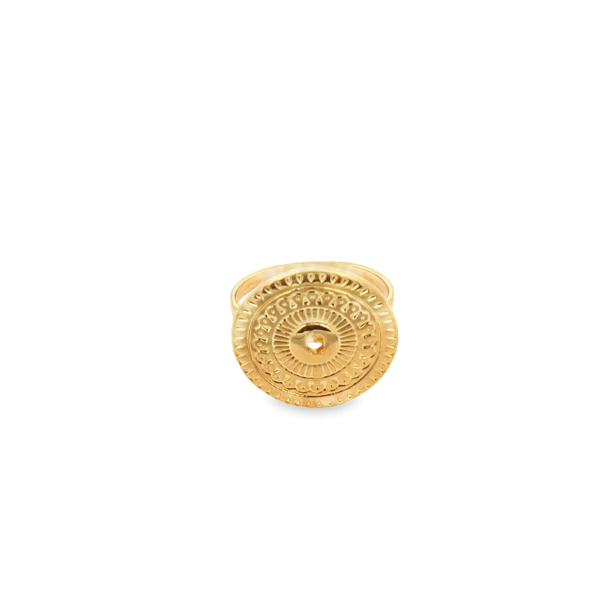A gold ring features an ornate, circular medallion with intricate embossed patterns against a clean white background.