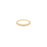 A delicate gold beaded ring rests against a clean white background.