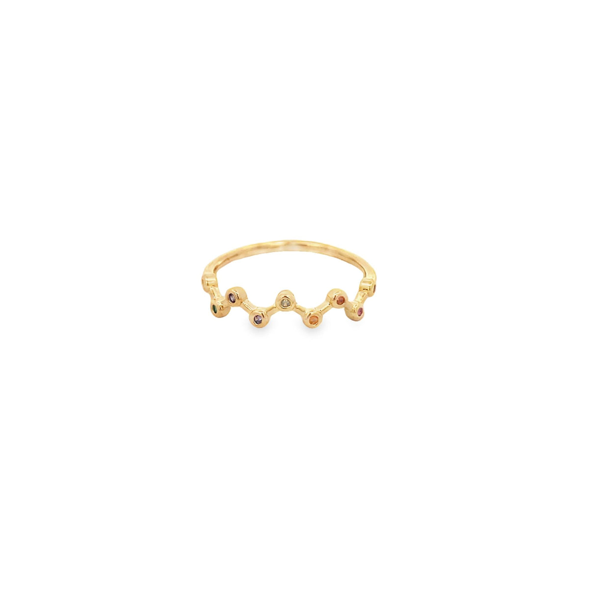 A delicate gold ring features a zig-zag band embellished with colorful bezel-set gemstones.