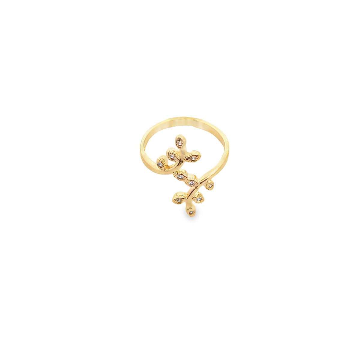 A delicate gold leaf ring adorned with sparkling cubic zirconia stones rests against a plain white background.