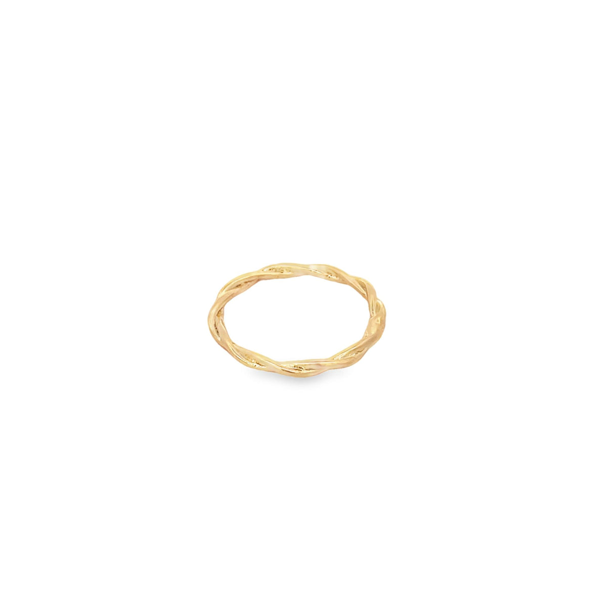 A minimalist twisted gold band ring rests on a plain white background.