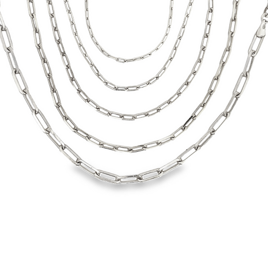 Five layered silver paperclip link necklaces drape gracefully against a clean white background.