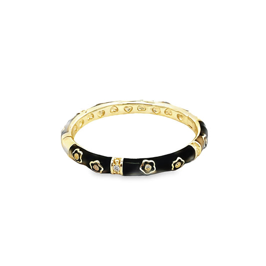 A gold and black enamel ring features sparkling diamond flower motifs and a heart-patterned inner band.