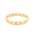 A polished gold bangle features intricate cut-out patterns along its band against a plain white background.