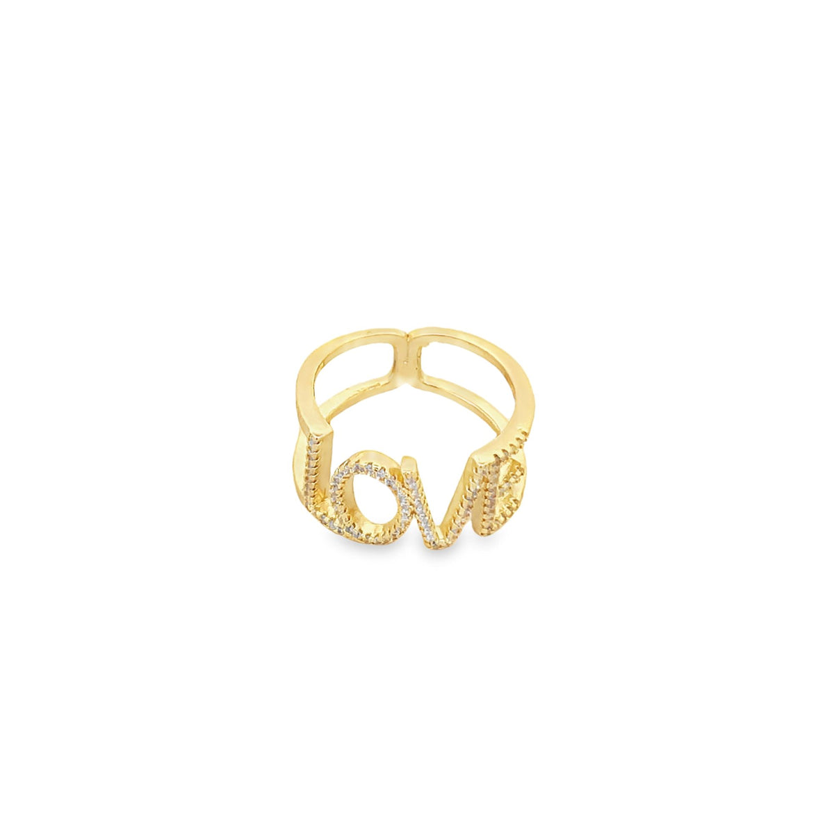 A gold ring featuring the word "love" spelled out in sparkling cubic zirconia stones rests against a plain white background.