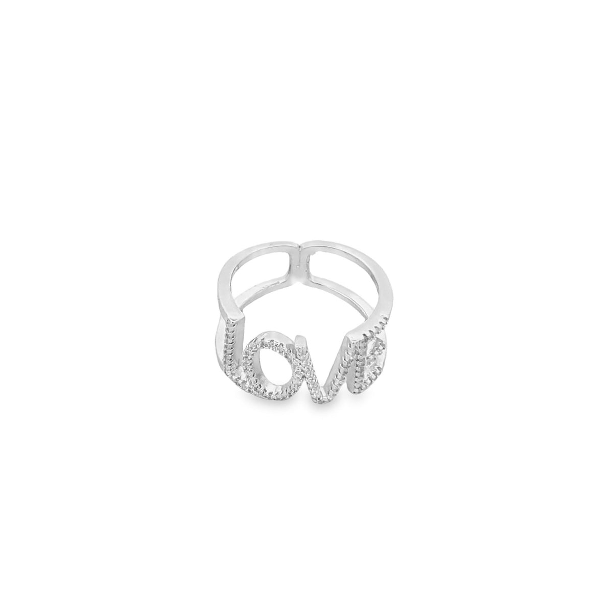 A sparkling silver ring displays the word "love" spelled out in pavé-set stones.
