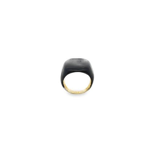 A sleek black enamel signet ring with a gold band rests against a white background.