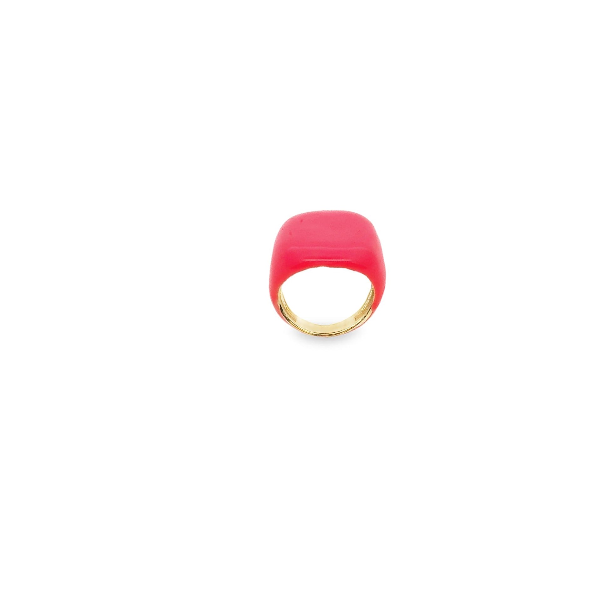 A vibrant pink enamel ring with a polished gold band sits centered against a clean white background.
