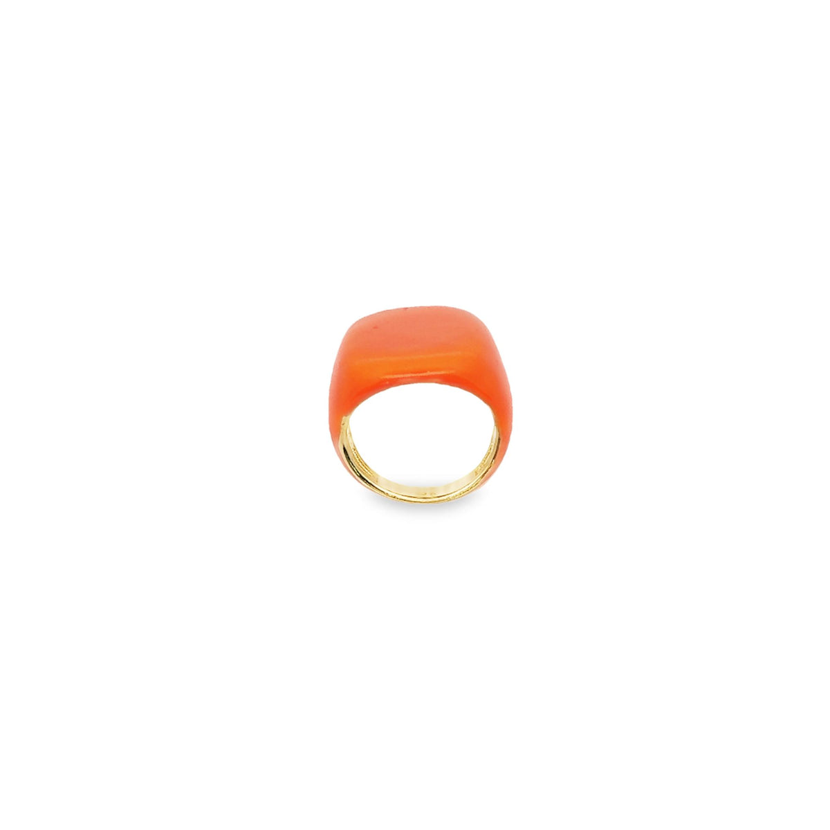A bright orange statement ring with a glossy finish rests against a clean white background.