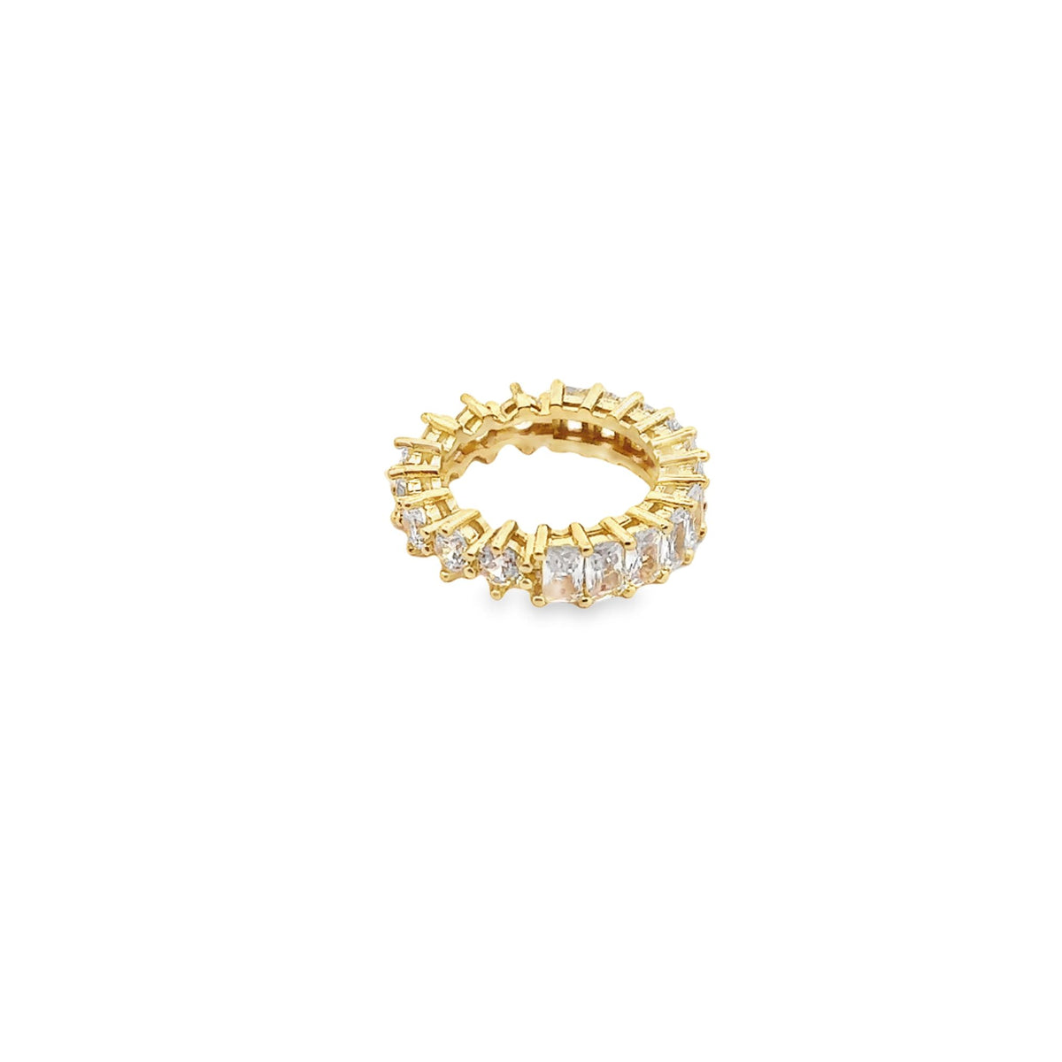 A gold eternity ring features an alternating pattern of round and emerald-cut cubic zirconia stones.