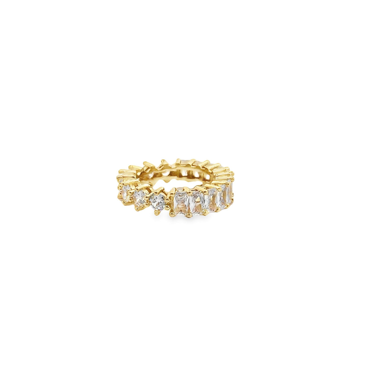 A gold eternity ring features alternating round and baguette-cut cubic zirconia stones sparkling against a clean white background.