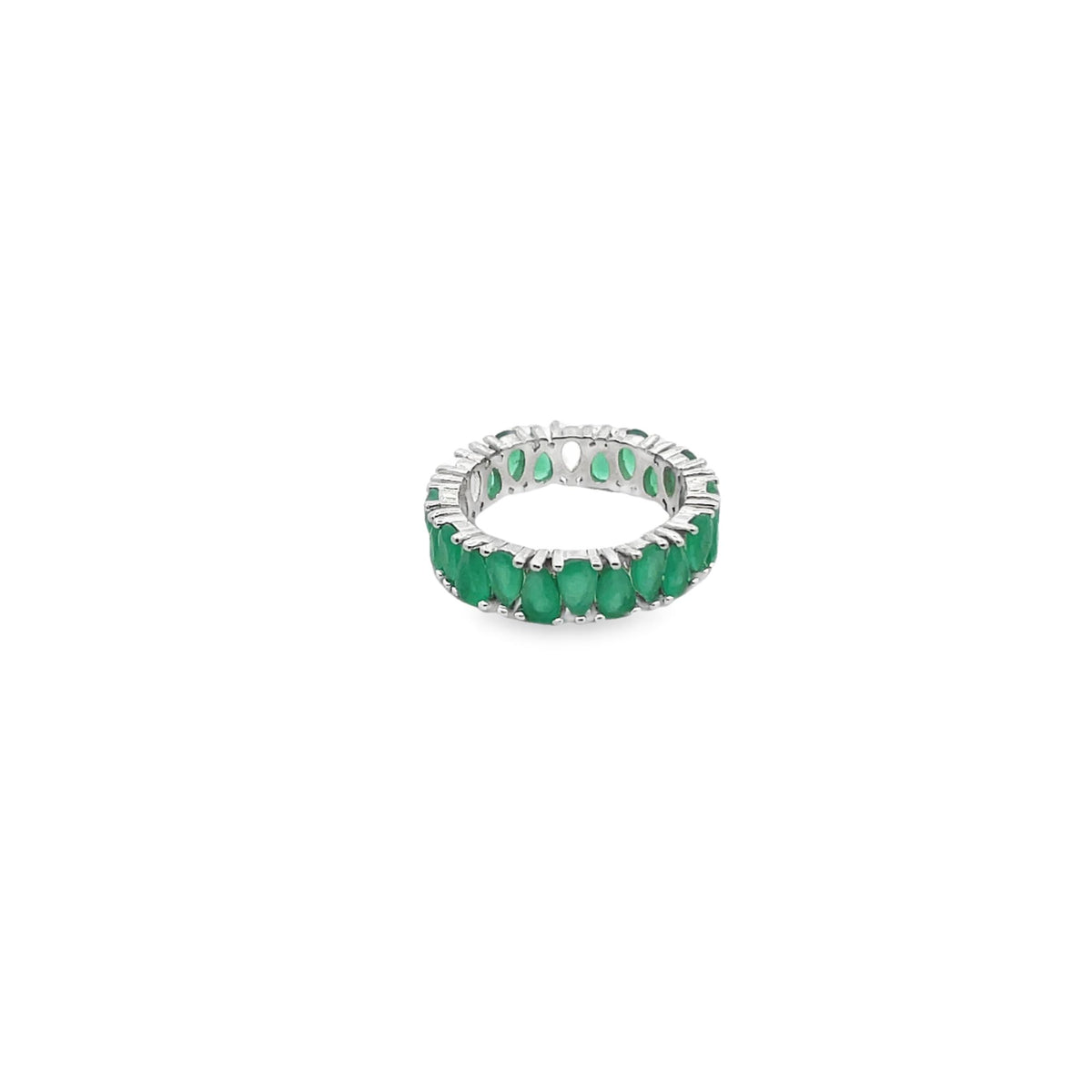 A silver eternity band features a continuous row of vibrant pear-cut emerald gemstones against a plain white background.