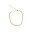 A delicate gold disc bracelet features a shiny linked chain and an adjustable clasp against a clean white background.