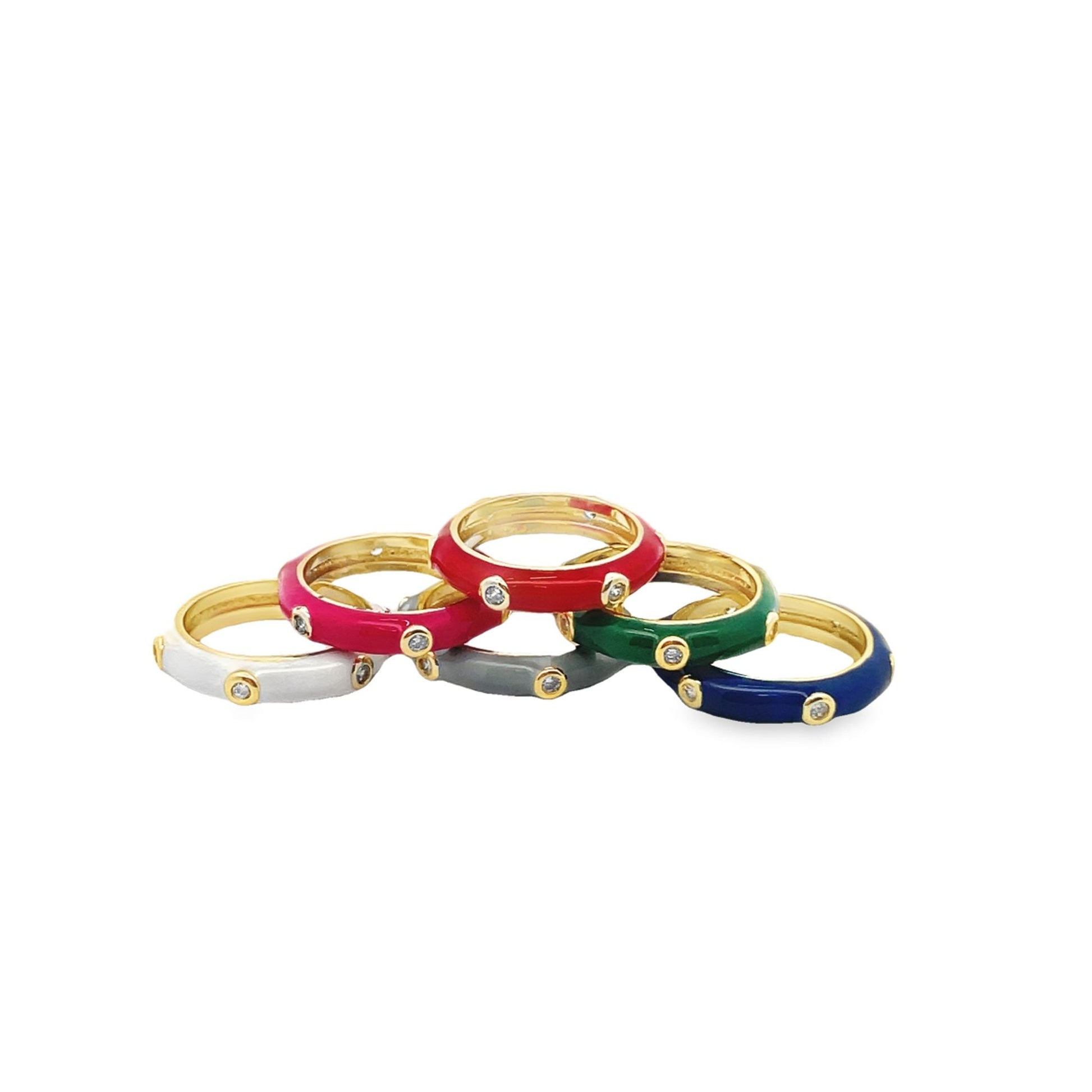 A small stack of colorful gold-plated enamel rings features inlaid sparkling diamonds against white, pink, red, grey, green, and blue backgrounds.